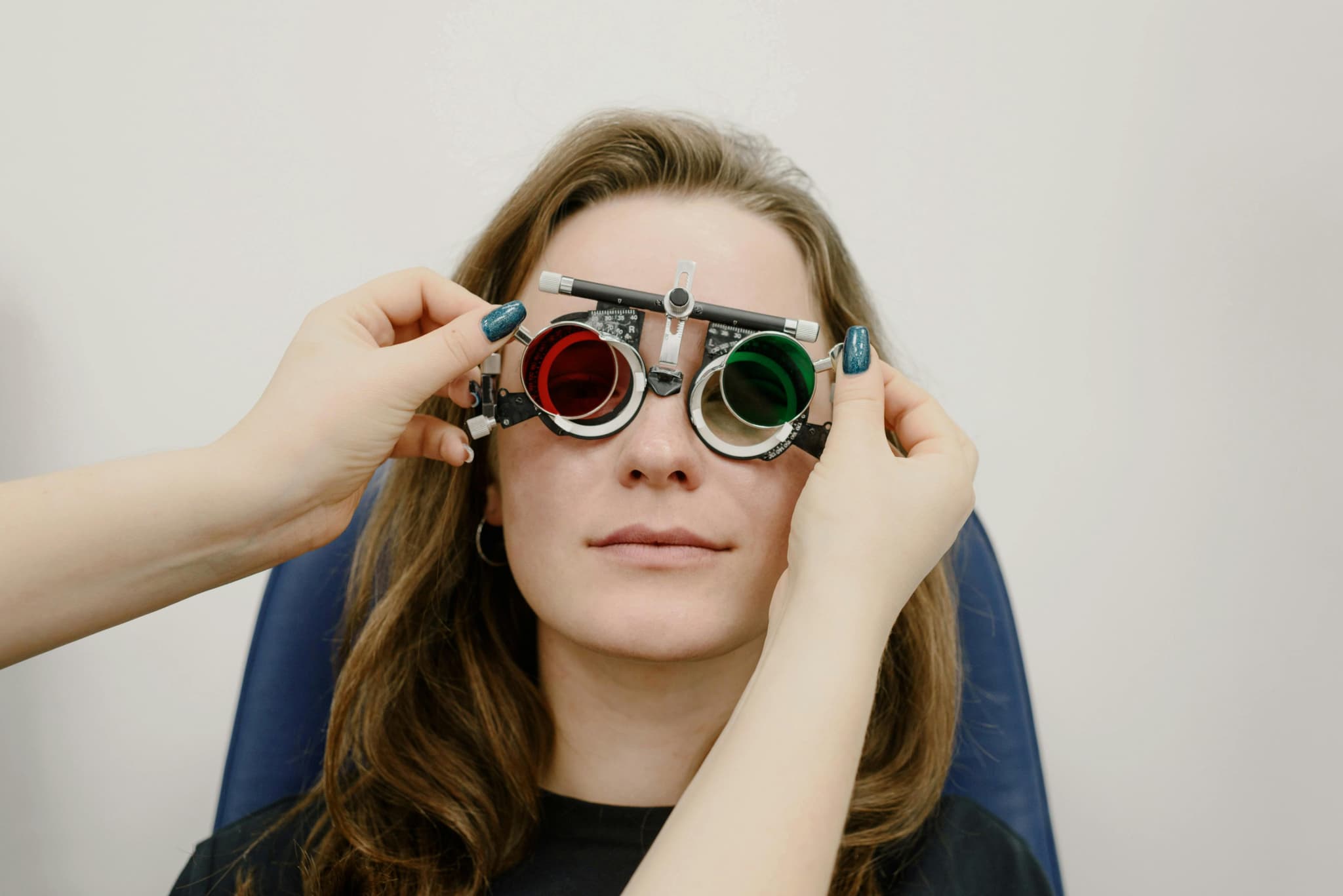 Optometrist fitting trial frames